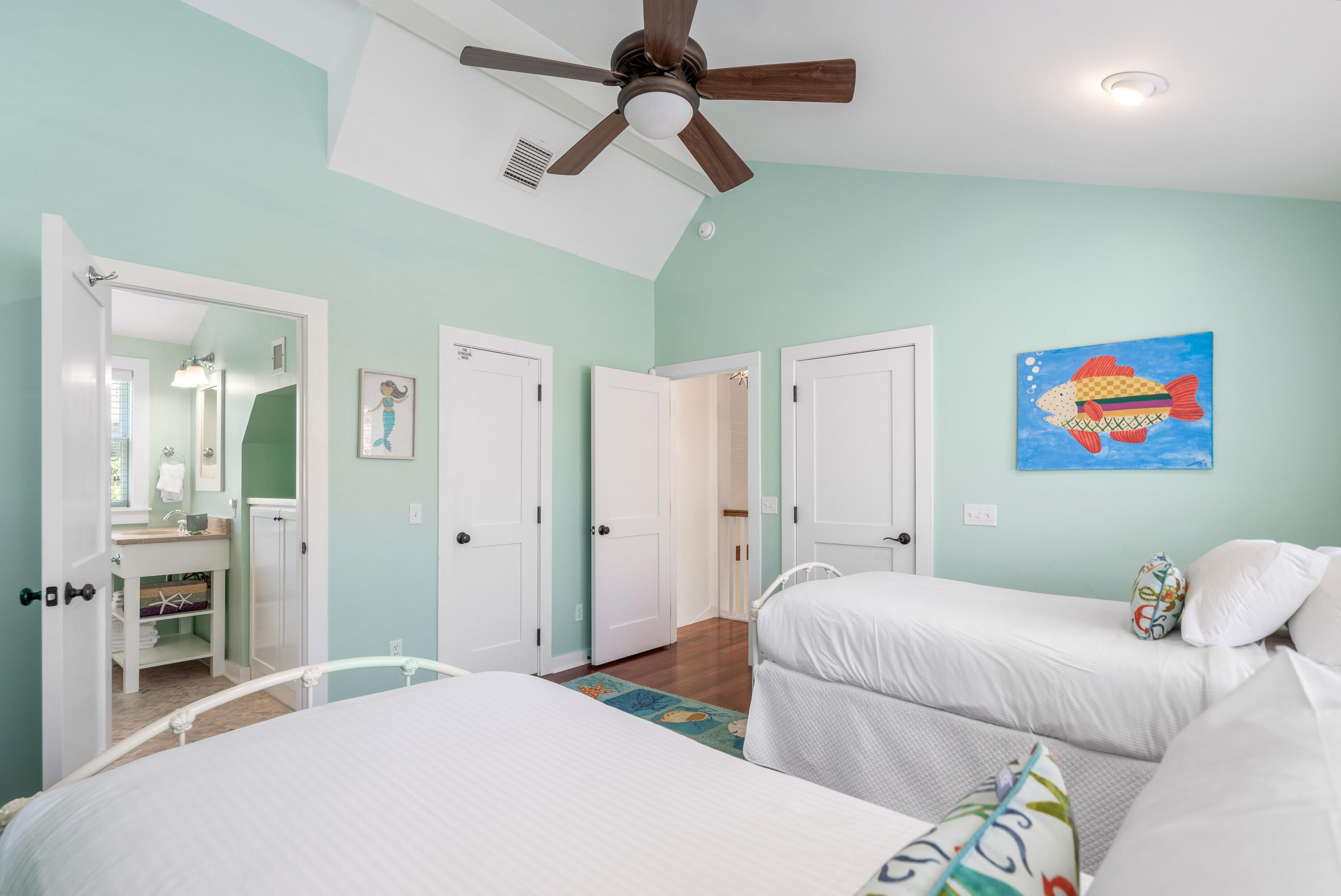 247 Salt Lane Watersound, FL 32461 - Photo 32 of 45 a bedroom with a bed and a chandelier