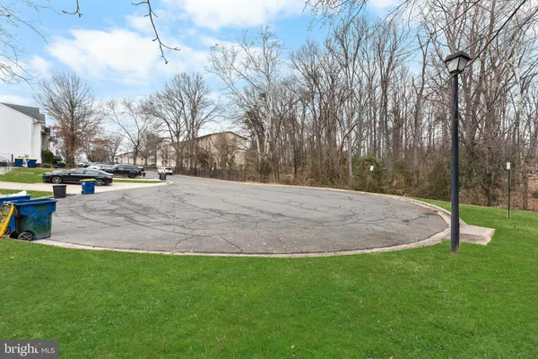 a backyard of apartments with large trees