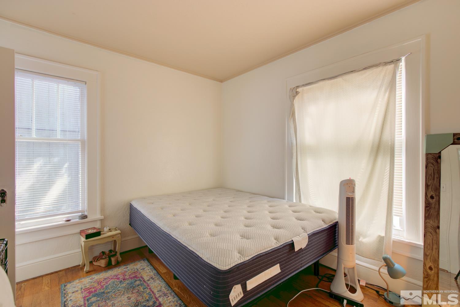 321 Crampton Street, Unit 1/2 Reno, NV 89502 - Photo 16 of 40 a bedroom with a bed and a table in it