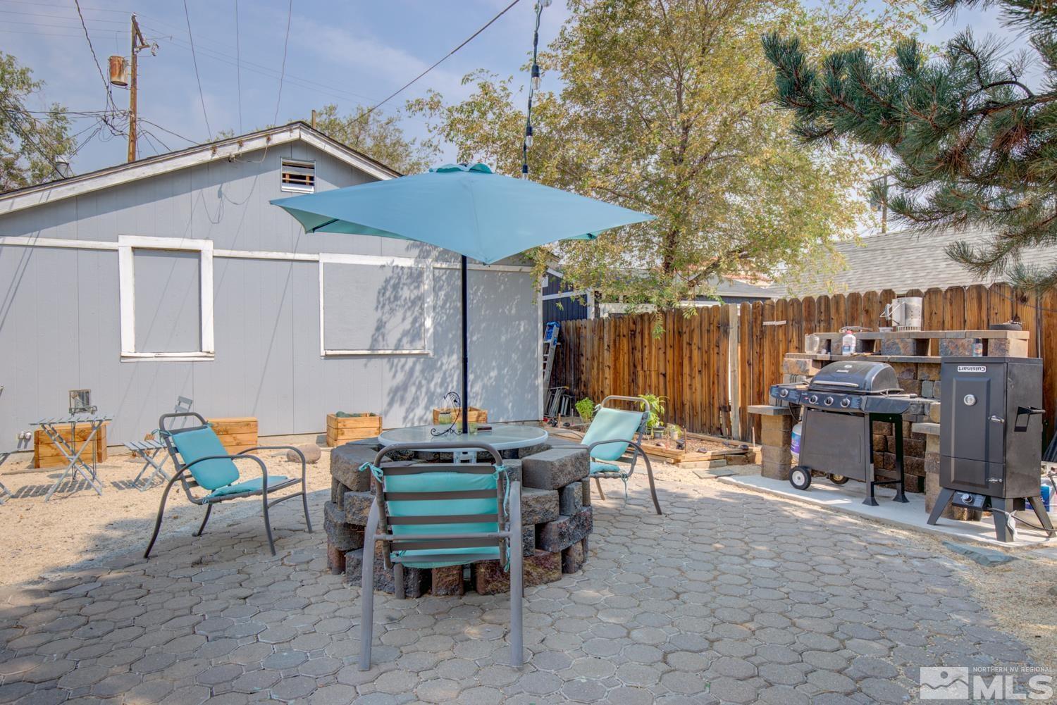 321 Crampton Street, Unit 1/2 Reno, NV 89502 - Photo 29 of 40 an outdoor sitting area with furniture and umbrella