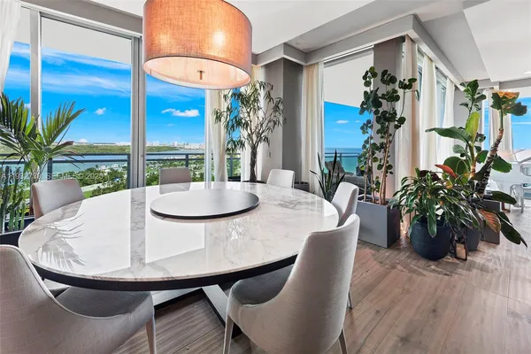 a dining room with furniture and wooden floor