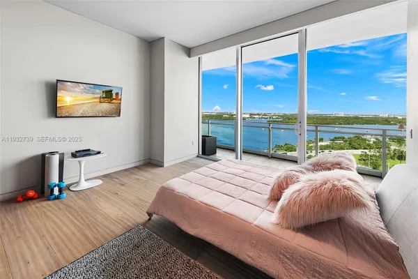 a bedroom with a large bed and a large window