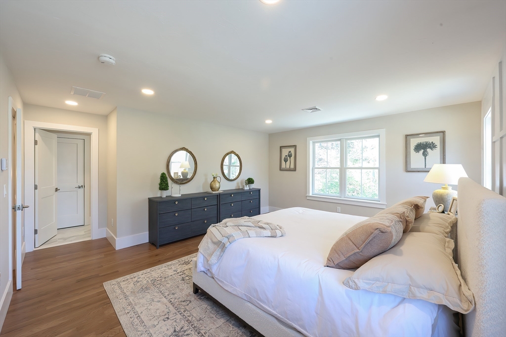 55 Thomas Mann Circle, Unit 32 Norfolk, MA 02056 - Photo 11 of 31 a bedroom with a bed and a window