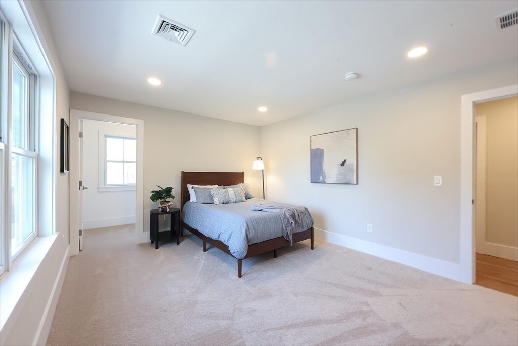 55 Thomas Mann Circle, Unit 32 Norfolk, MA 02056 - Photo 18 of 31 a spacious bedroom with a bed and a window