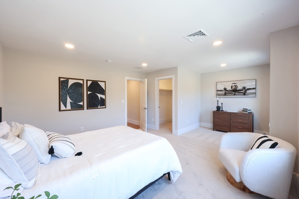 55 Thomas Mann Circle, Unit 32 Norfolk, MA 02056 - Photo 19 of 31 a spacious bedroom with a bed and couch