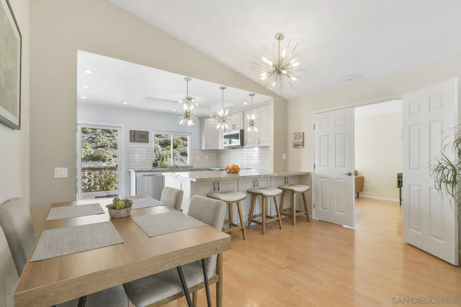12061 Rue Des Amis San Diego, CA 92131 - Photo 12 of 33 a view of a dining room with furniture and chandelier