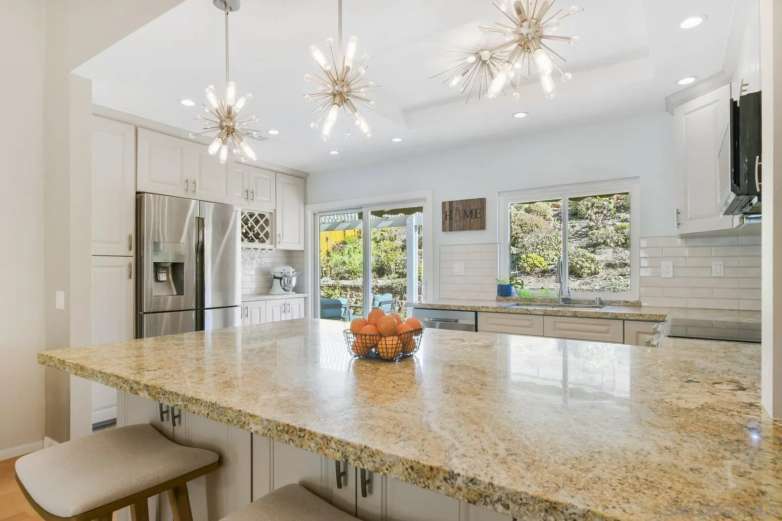 12061 Rue Des Amis San Diego, CA 92131 - Photo 14 of 33 a view of a kitchen with kitchen island stainless steel appliances a table and chairs