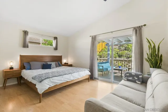 a bedroom with a large bed and ceiling fan