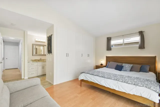 a bedroom with a bed couches and a couch