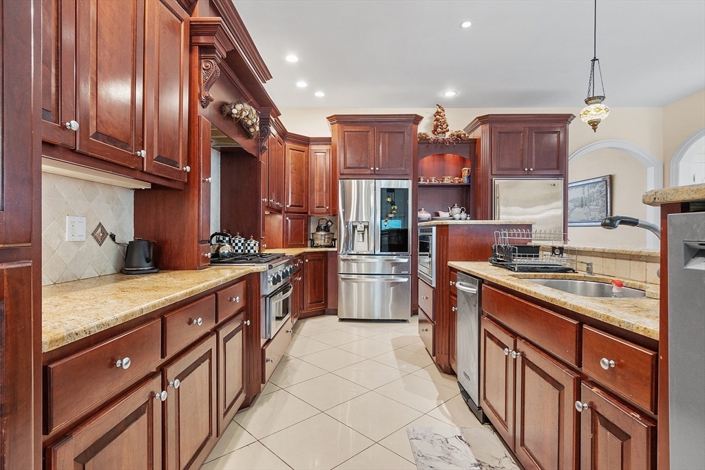 30 Bridle Path Shrewsbury, MA 01545 - Photo 11 of 41 a kitchen with stainless steel appliances granite countertop a sink a stove and a refrigerator