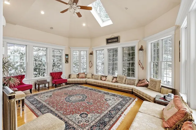 a living room with rug floor to ceiling window and a rug