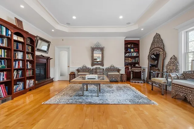 a living room with furniture and a book shelf