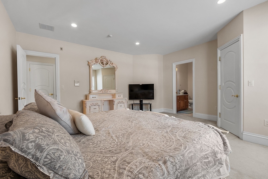30 Bridle Path Shrewsbury, MA 01545 - Photo 25 of 41 a bedroom with a bed and a flat screen tv