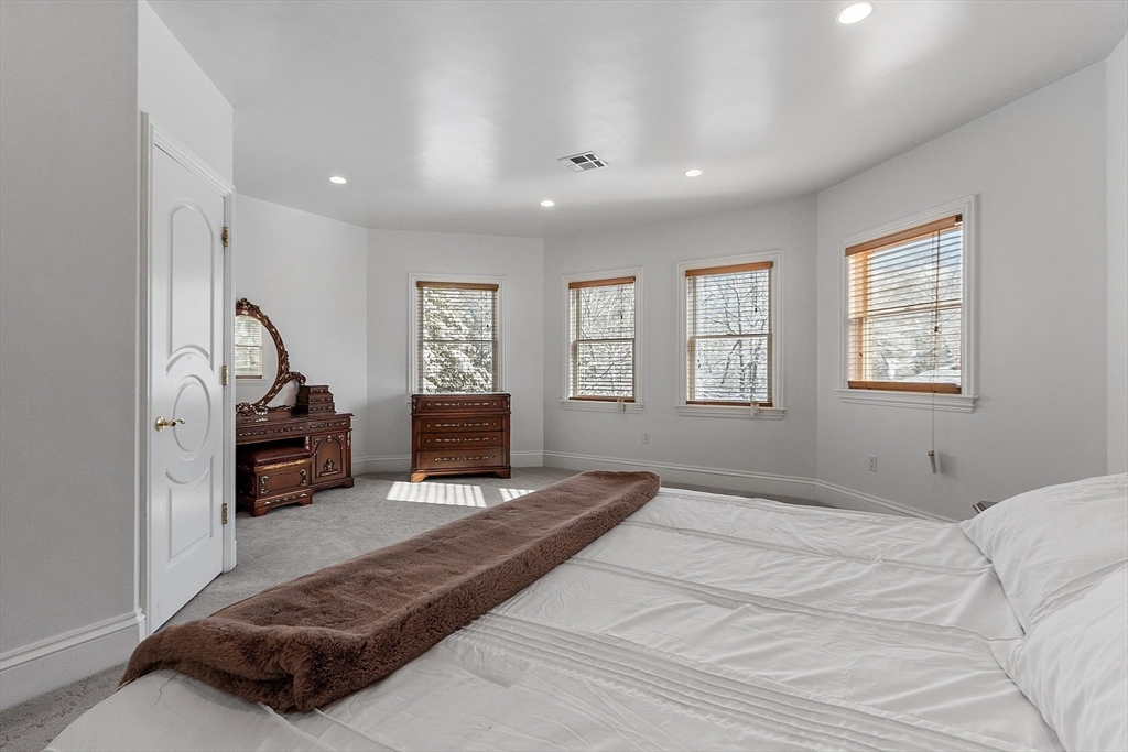 30 Bridle Path Shrewsbury, MA 01545 - Photo 26 of 41 a bedroom with a bed a chandelier and a dresser