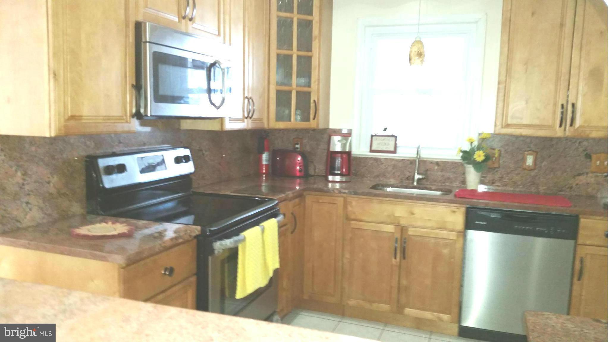 7510 Saffron Court Hanover, MD 21076 - Photo 2 of 30 a kitchen with a sink stove and cabinets