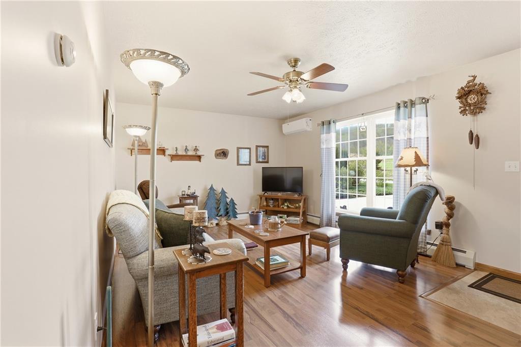 695 Greenhouse Road Rockwood, PA 15557 - Photo 11 of 50 a living room with furniture a ceiling fan and a large window