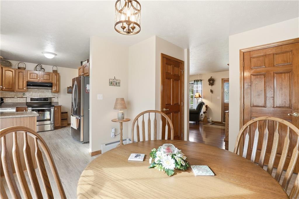 695 Greenhouse Road Rockwood, PA 15557 - Photo 13 of 50 a view of a dining room with furniture a kitchen and chandelier
