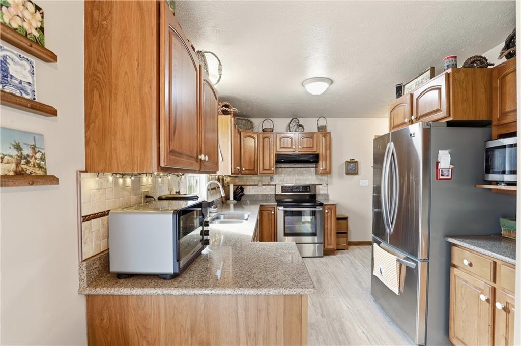 695 Greenhouse Road Rockwood, PA 15557 - Photo 14 of 50 a kitchen with granite countertop a refrigerator stove and sink