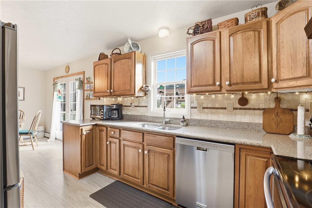 695 Greenhouse Road Rockwood, PA 15557 - Photo 15 of 50 a kitchen with stainless steel appliances granite countertop a sink a stove and cabinets