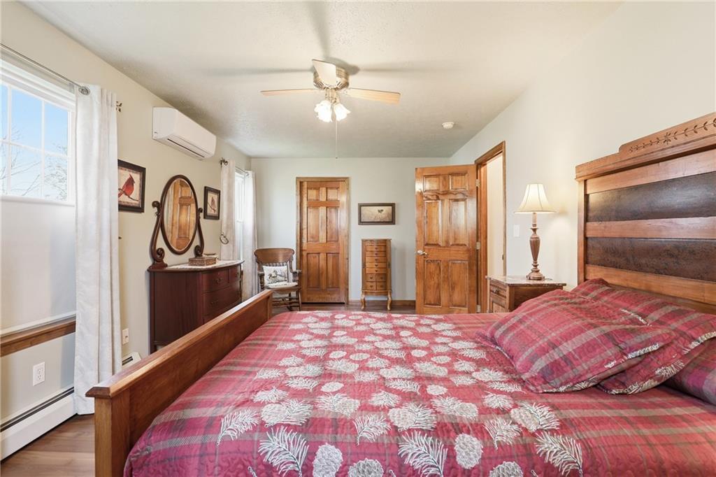 695 Greenhouse Road Rockwood, PA 15557 - Photo 24 of 50 a bedroom with a large bed and a chandelier