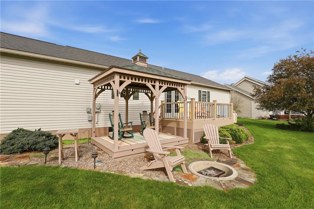 695 Greenhouse Road Rockwood, PA 15557 - Photo 37 of 50 a view of a white house with a patio table and chairs