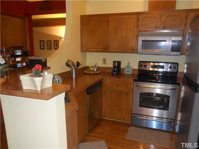3507 Mill Run Raleigh, NC 27612 - Photo 3 of 16 a kitchen with a stove and a microwave