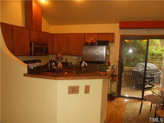 3507 Mill Run Raleigh, NC 27612 - Photo 4 of 16 a kitchen with a sink and a stove top oven