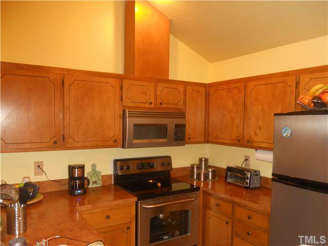 3507 Mill Run Raleigh, NC 27612 - Photo 5 of 16 a kitchen with stainless steel appliances granite countertop a stove a sink and a microwave