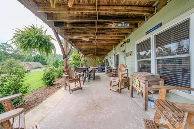 a view of a porch with chairs and potted plants