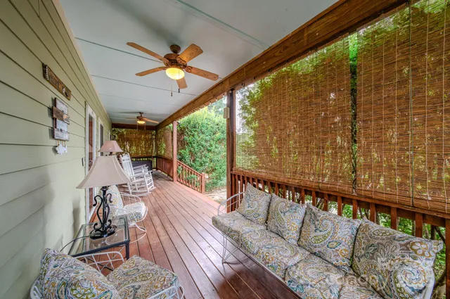 a view of a living room with a table and chairs