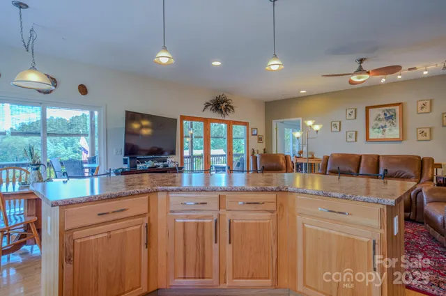 a kitchen with cabinets and chairs