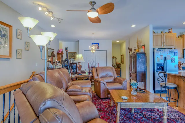 a living room with furniture and kitchen view
