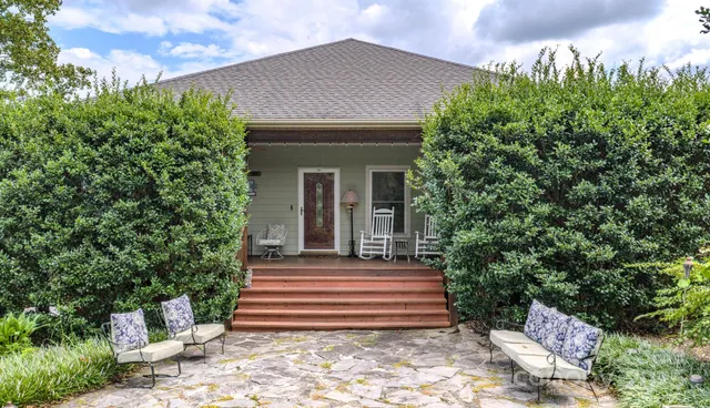 a front view of a house with a garden