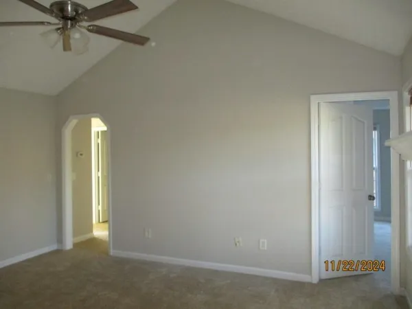 an empty room with a empty space and a ceiling fan