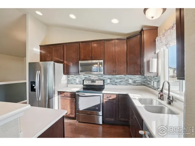 a kitchen with kitchen island a sink appliances and cabinets