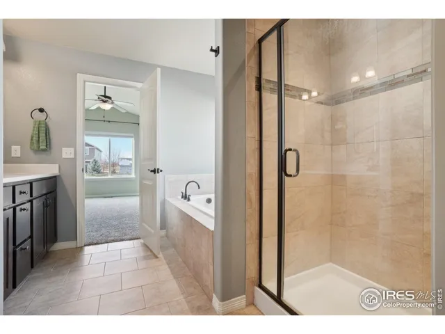 a bathroom with a tub shower and sink