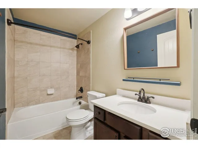 a bathroom with a sink a toilet a mirror and shower