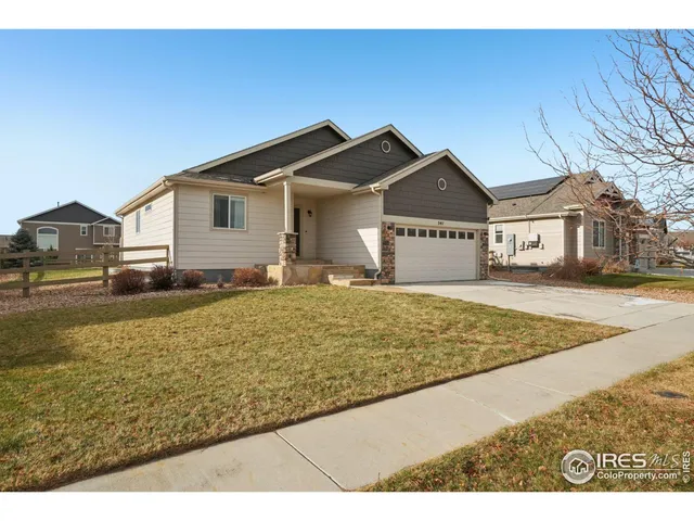 a view of an house with backyard and trees