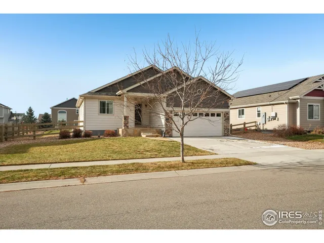 a view of a house with a yard and sitting area