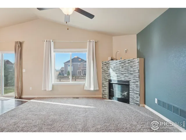 a view of empty room with fireplace and window