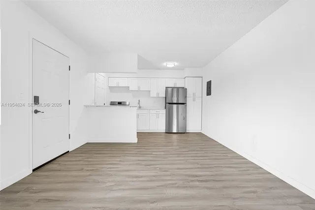 a kitchen with stainless steel appliances a refrigerator sink and microwave