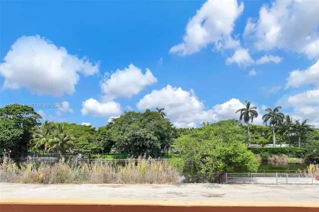 a backyard of a house with a garden and barbeque oven