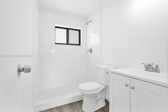 a white toilet sitting next to a bathroom sink
