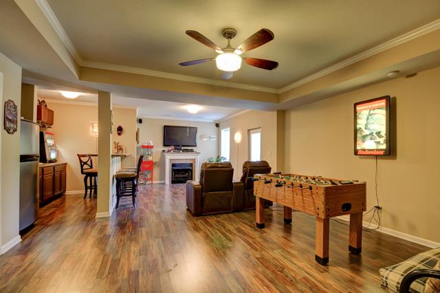 3456 Lake Road Woodlawn, TN 37191 - Photo 13 of 20 welcome to the lower level which features engineered hardwood flooring,fireplace,bar area,crown molding thru out as well as seperate entrance -this would make a great entertainment area or perhaps an in law or teenager suite