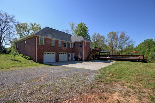 3456 Lake Road Woodlawn, TN 37191 - Photo 16 of 20 View of the back of home-which features deck on upper level tiered down to pool area
