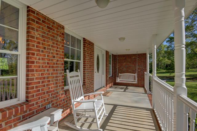 3456 Lake Road Woodlawn, TN 37191 - Photo 18 of 20 Spacious front porch with rockers and swing which are included in the sale