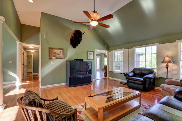 Spacious great room has wiring for surround sound-custom shutters on windows