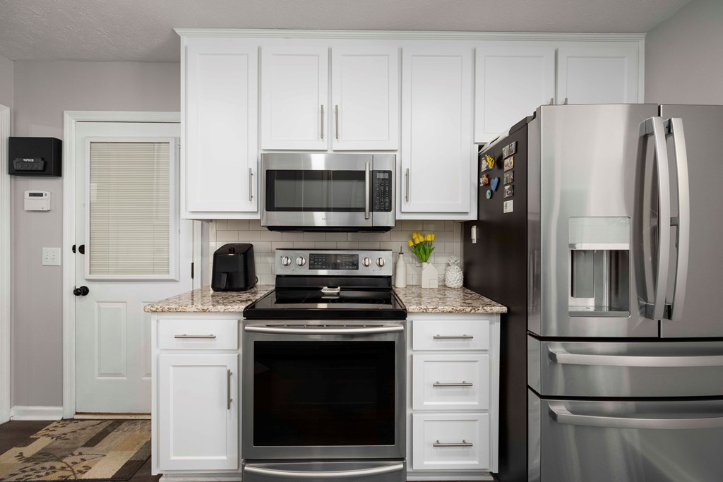 5017 Emerald Isle Court Columbus, GA 31909 - Photo 14 of 37 a kitchen with a refrigerator stove and white cabinets
