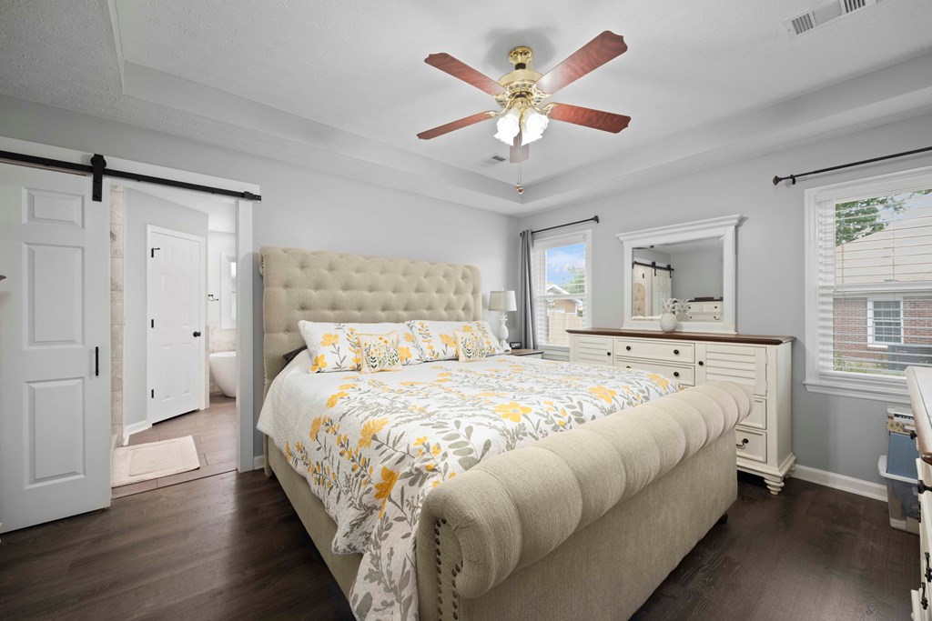 5017 Emerald Isle Court Columbus, GA 31909 - Photo 16 of 37 a spacious bedroom with a large bed and a chandelier