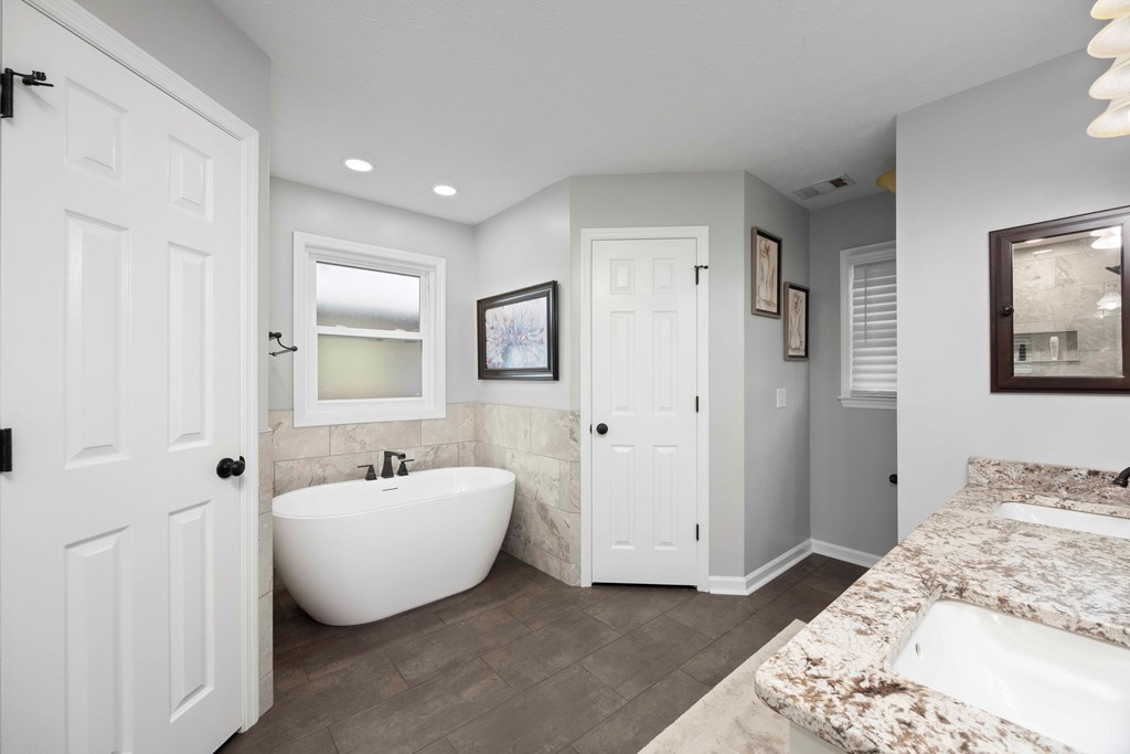 5017 Emerald Isle Court Columbus, GA 31909 - Photo 17 of 37 a spacious bedroom with a bed and a couch